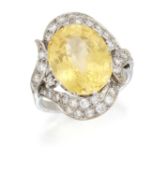 A YELLOW SAPPHIRE AND DIAMOND CLUSTER RING