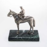 AN ELIZABETH II SILVER MODEL OF A RACEHORSE AND JOCKEY