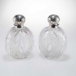 A LARGE PAIR OF VICTORIAN SILVER-TOPPED CUT-GLASS EAU DE COLOGNE BOTTLES