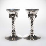 GEORG JENSEN: A PAIR OF DANISH STERLING SILVER 'GRAPE' PATTERN CANDLESTICKS