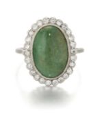 AN EARLY 20TH CENTURY JADE AND DIAMOND CLUSTER RING
