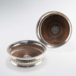 A PAIR OF GEORGE III SILVER WINE COASTERS