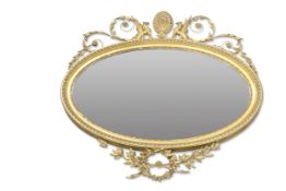 A 19TH CENTURY GILT-COMPOSTITION OVAL MIRROR