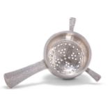 AN ARTS AND CRAFTS SILVER TEA STRAINER