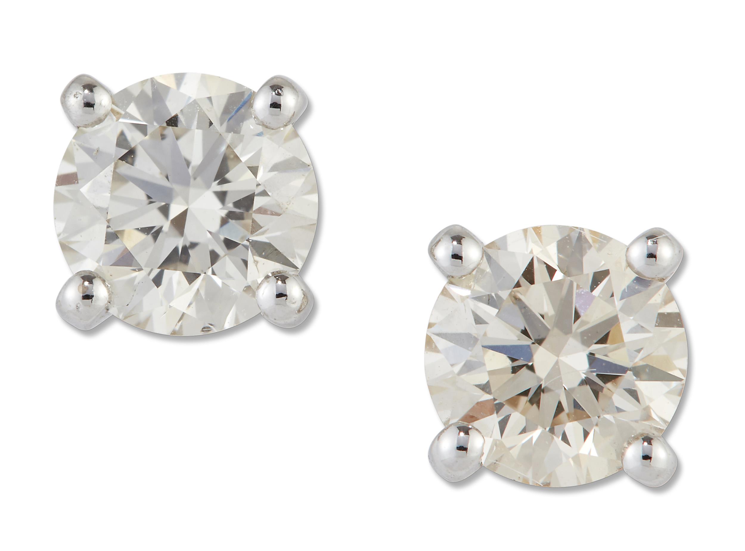 A PAIR OF SOLITAIRE DIAMOND EARRINGS