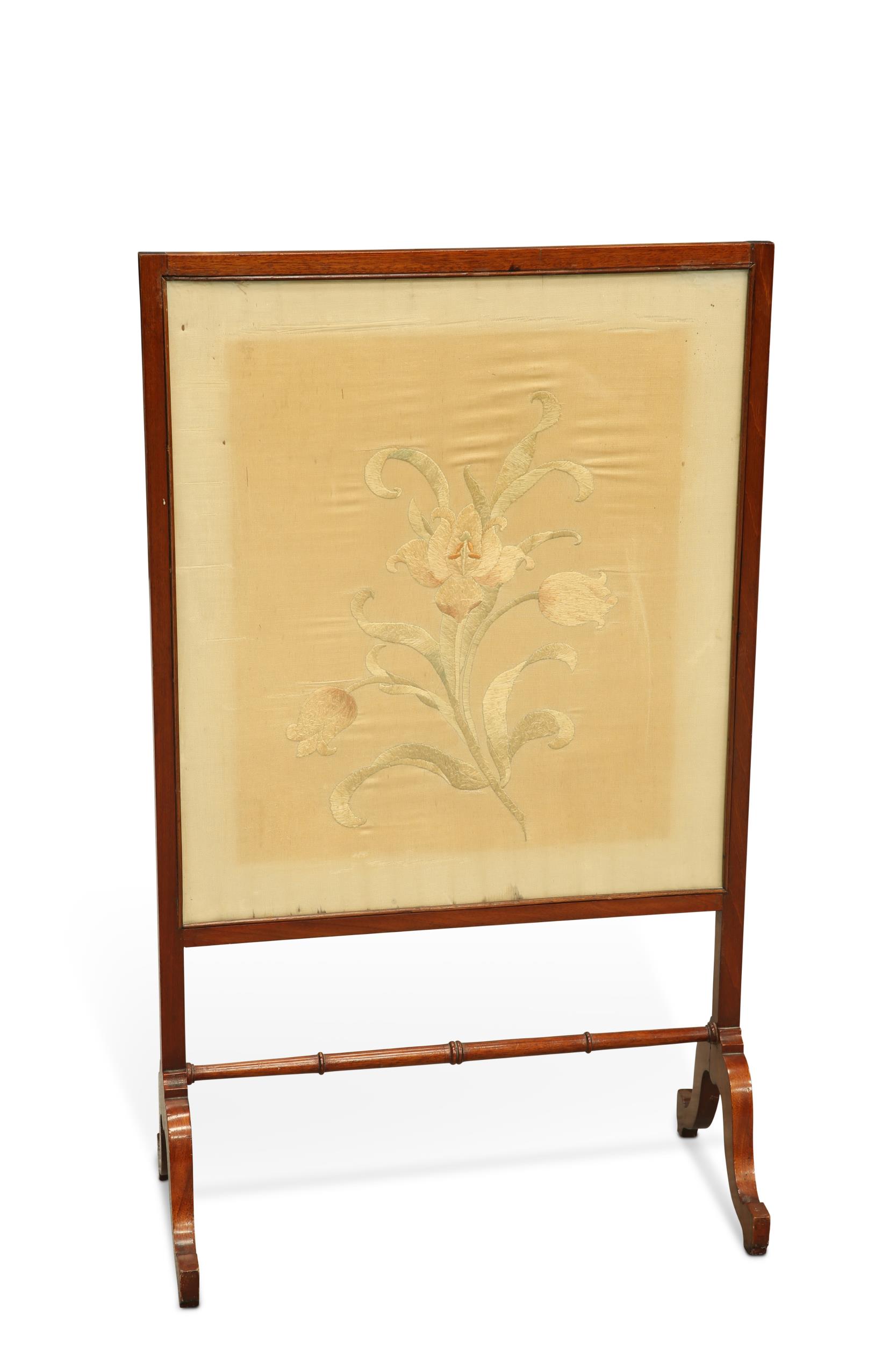 AN EDWARDIAN MAHOGANY AND NEEDLEWORK FIRESCREEN