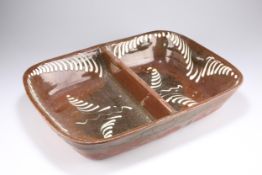 A 19TH CENTURY LARGE SLIPWARE TERRACOTTA TWO-DIVISION SERVING DISH
