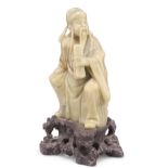 A CHINESE CARVED SOAPSTONE FIGURE OF IMMORTAL CAO GUOJIU