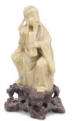 A CHINESE CARVED SOAPSTONE FIGURE OF IMMORTAL CAO GUOJIU