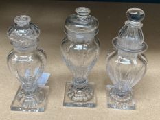 THREE ENGLISH GLASS CONDIMENT BOTTLES AND STOPPERS