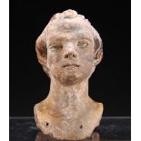 A TERRACOTTA HEAD OF A MAN