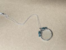 A MAGNIFYING GLASS ON PENDANT CHAIN