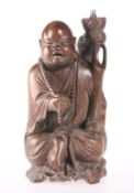 A CHINESE CARVED HARDWOOD FIGURE OF BUDDHA