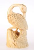 A CARVED IVORY FIGURE OF A PEACOCK