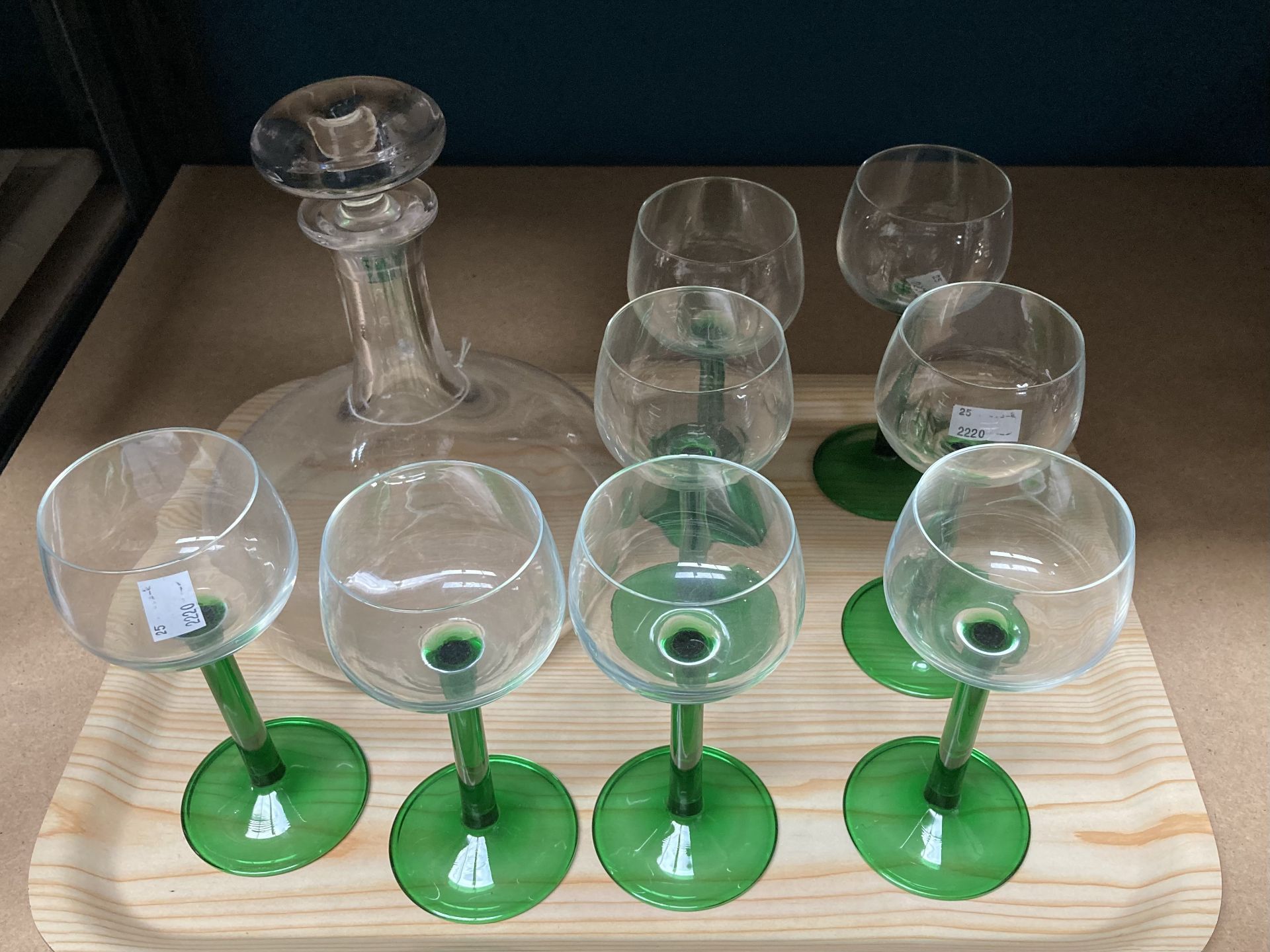 A SET OF EIGHT GREEN STEMMED WINE GLASSES AND A SHIP'S DECANTER