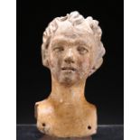 A TERRACOTTA HEAD OF A LADY