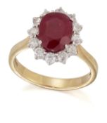AN 18 CARAT GOLD RUBY AND DIAMOND CLUSTER RING