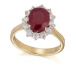 AN 18 CARAT GOLD RUBY AND DIAMOND CLUSTER RING