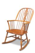 A CRYER CRAFT ELM WINDSOR ROCKING CHAIR, the arched toprail above a shaped backsplat and spindles,