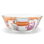 A CHINESE FAMILLE ROSE BOWL, shaped circular, with continuous decoration depicting figures to the