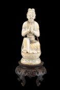 A CHINESE CARVED IVORY FIGURE OF AN ACOLYTE, QING DYNASTY, 17TH-18TH CENTURY, carved sitting in