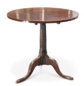 A GEORGE III MAHOGANY TILT-TOP TRIPOD TABLE, the circular top raised on a fluted stem, continuing to