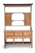 A GEORGE III OAK DRESSER, the base with moulded top over three frieze drawers with chequer-inlaid