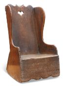 A CHILD'S OAK ROCKING CHAIR, PROBABLY CUMBRIAN, the plank back with a scroll crest and heart