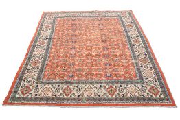 A TURKISH CARPET, CIRCA 1970,ÿthe orange field with all-over design of flowerheads and sprays, the