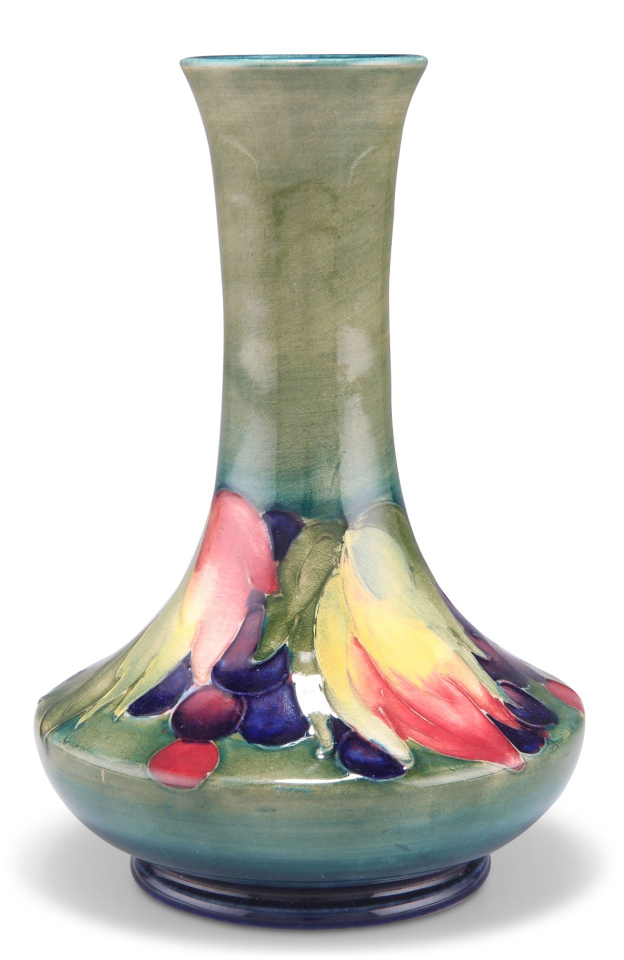 A WALTER MOORCROFT POTTERY VASE, squat baluster form with a long flared neck, 'Leaves and Berries'