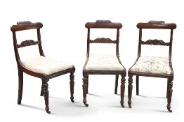 A SET OF THREE REGENCY ROSEWOOD SIDE CHAIRS,ÿeach with acanthus carved crest, raised on reeded