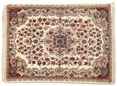 A NORTH PERSIAN RUG, hand-knotted, the cream field with scrolling foliate design in dark red, blue