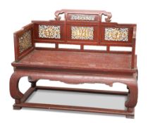 A CHINESE RED LACQUERED BENCH, with gilded fret-carved figural and foliate panels. Height of back