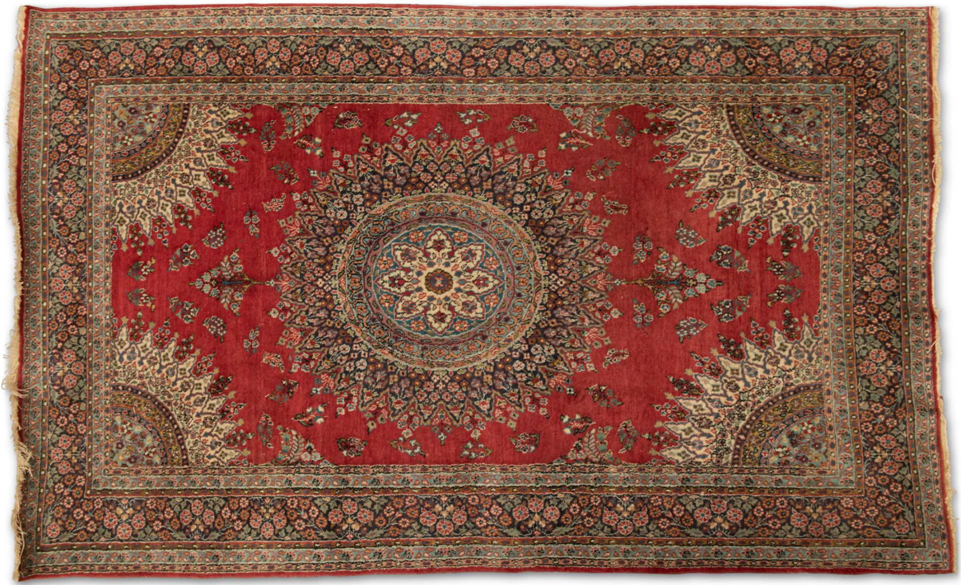 A PERSIAN RUG, hand-knotted, the deep red field with a highly decorative cream and blue circular