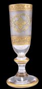 A CONTINENTAL HEAVY GILT CHAMPAGNE GLASS, the frosted tapering bowl with gilt decoration, to a