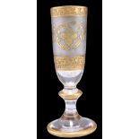 A CONTINENTAL HEAVY GILT CHAMPAGNE GLASS, the frosted tapering bowl with gilt decoration, to a