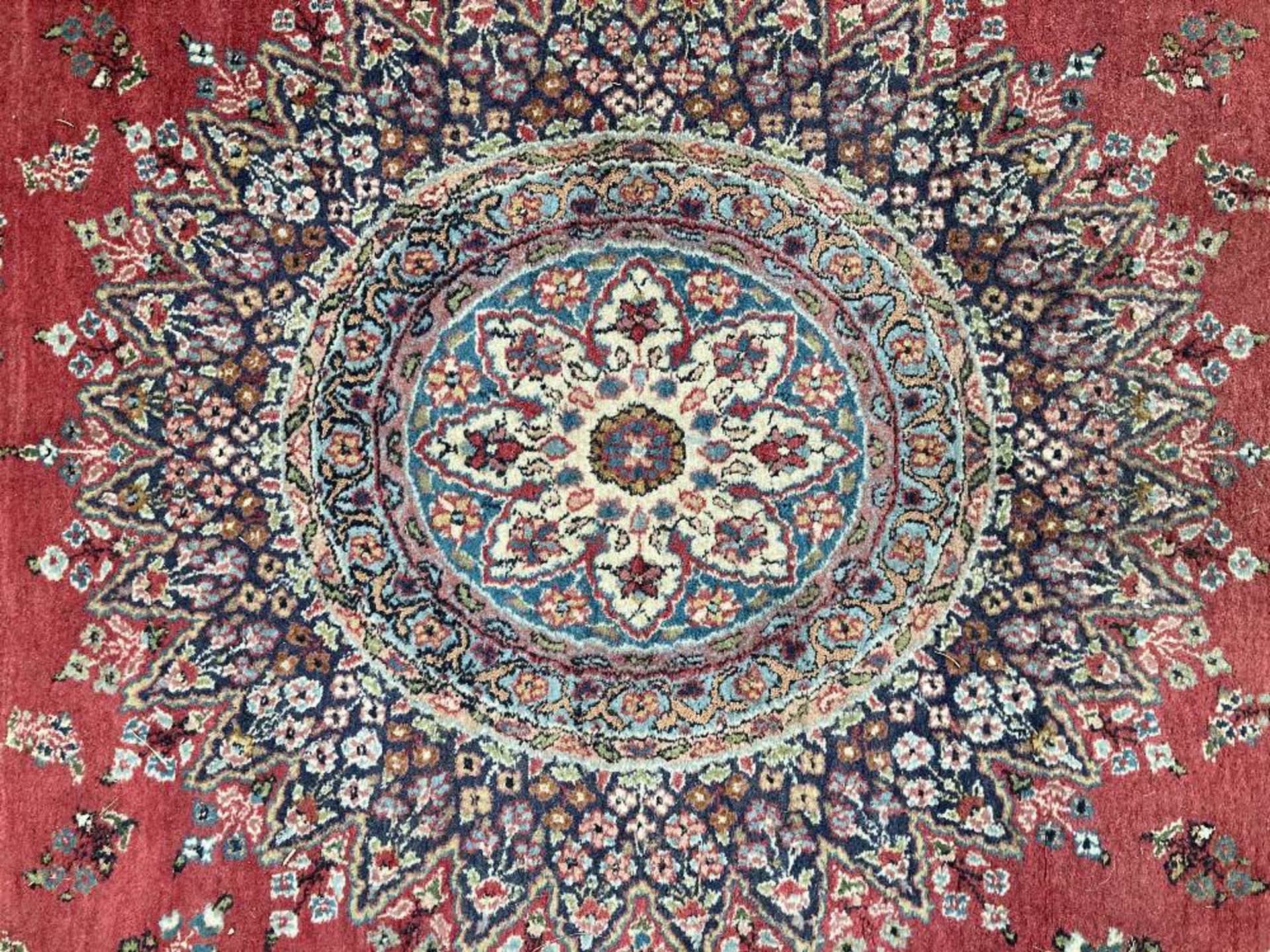 A PERSIAN RUG, hand-knotted, the deep red field with a highly decorative cream and blue circular - Image 2 of 4