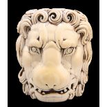A LARGE CARVED IVORY HEAD OF A LION, carved in the round, with boldly curled mane and open mouth