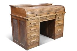 A 20TH CENTURY OAK TAMBOUR ROLL TOP DESK, the shallow tambour roll revealing a fitted interior