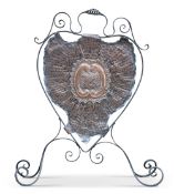 AN ARTS AND CRAFTS COPPER AND WROUGHT IRON FIRESCREEN, of scrolling cartouche form. 91cm high,