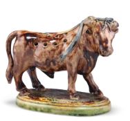 A 19TH CENTURY MAJOLICA NOVELTY TOOTHPICK HOLDER, in the form of a prize bull, on a naturalistic