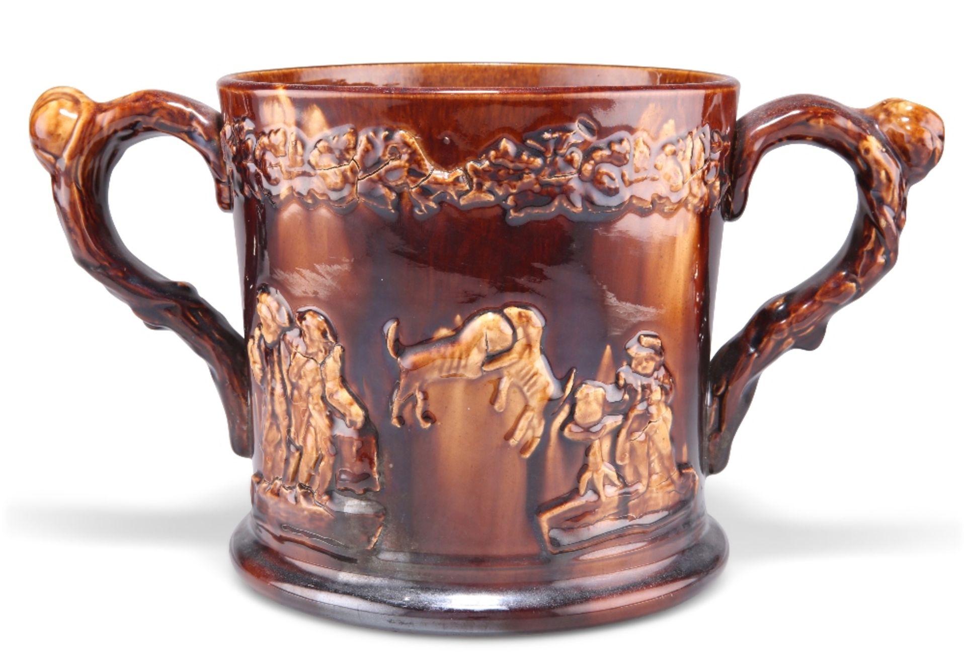 A LARGE 19TH CENTURY STAFFORDSHIRE TREACLE GLAZE LOVING CUP, moulded decoration depicting tavern