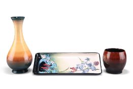 THREE PIECES OF MOORCROFT POTTERY, comprising a trial pin tray, rectangular, 20cm by 9cm; a trial