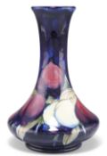 A WILLIAM MOORCROFT POTTERY VASE,ÿsquat baluster form with a long flared neck, 'Plum Wisteria'