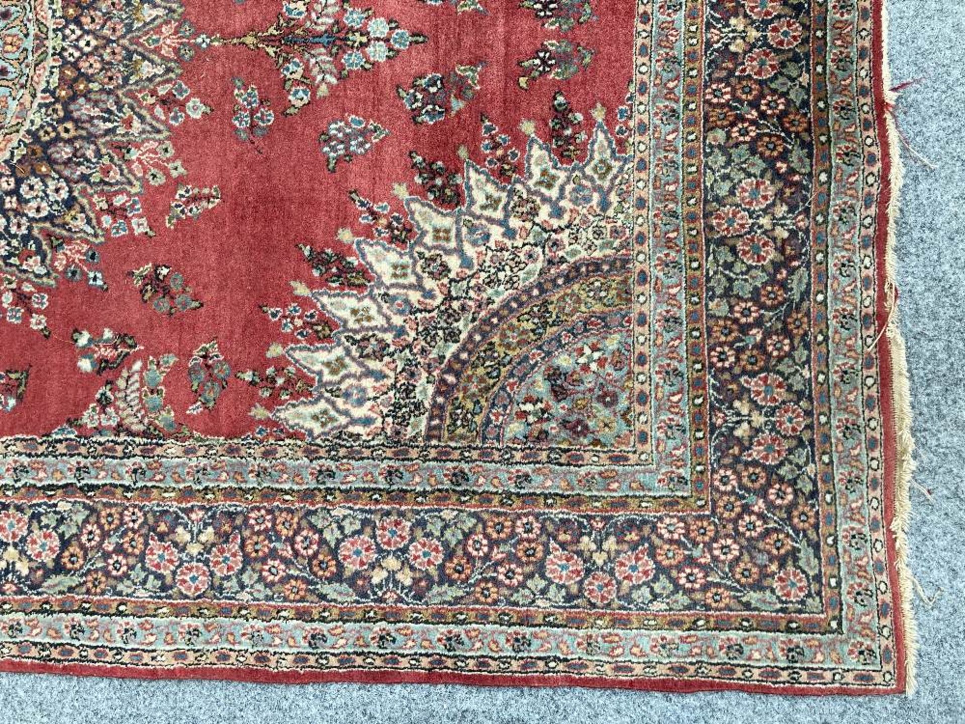 A PERSIAN RUG, hand-knotted, the deep red field with a highly decorative cream and blue circular - Image 3 of 4