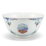 A CHINESE DOUCAI BOWL, with deep rounded sides and standing on a short foot, painted and enamelled