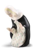 PAOLA BOLOGNA FOR LENCI, A POTTERY FIGURE OF THE MADONNA, in keeling pose with hands raised, wearing