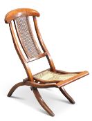 A MAHOGANY AND CANEWORK FOLDING CAMPAIGN CHAIR, 19TH CENTURY,ÿthe low seat and scrolling back each