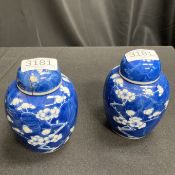 A PAIR OF CHINESE BLUE AND WHITE PRUNUS GINGER JARS AND COVERS