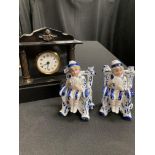 Two pressed porcelain figures of boys, and a black slate mantel clock